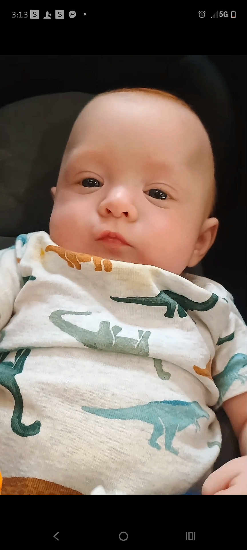Klayse joined the competition — help win amazing prizes! baby, infant, face, dinosaur_pattern, onesie, clothing, child, portrait, cute, young, skin, eyes, head, expression, lying_down, soft_lighting, indoor, closeup, person, adorable