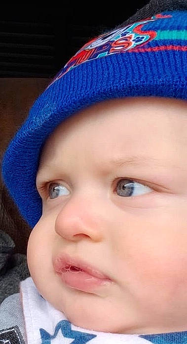 Brian is registered to the contest to win money with this photo: baby, beanie, bonnet, cap, cheek, child, chin, close_up, eye, eyebrow, face, forehead, head, headgear, knit_cap, lip, mouth, nose, person, skin