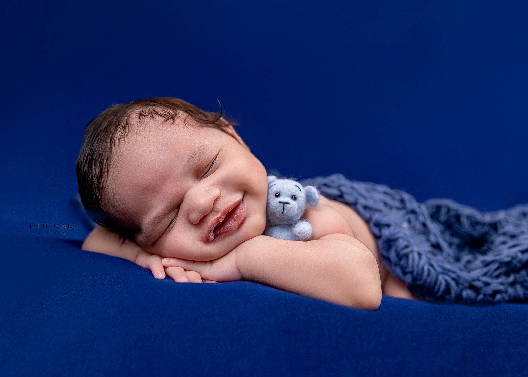 Callum is registered to the contest to win money with this photo: baby, baby_toddler_clothing, child, comfort, darkness, electric_blue, flash_photography, fun, happy, linens, person, portrait, portrait_photography, sitting, sleeve, smile, toddler