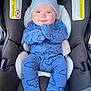 baby, infant, car_seat, blue_onesie, hat, smiling, cute, child, face, clothing, seat, safety, adorable, young, person, indoor, expression, happy, hands, wrapped