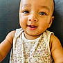 Leo joined the competition — help win amazing prizes! arm, baby, background, child, closeup, clothing, cute, eyes, face, floral_pattern, happy, indoors, infant, lying_down, person, portrait, skin, sleeveless, smiling, young
