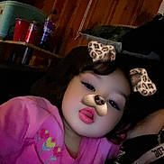 Delilah joined the competition — help win amazing prizes! child, pink_shirt, dog_filter, leopard_ears, nose_filter, selfie, face, tongue_out, indoor, wooden_wall, framed_photos, shelf, cups, purple_bottle, toy, casual, cute, young_child, playful, cozy