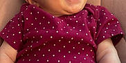 Rose is registered to the contest to win money with this photo: baby, infant, smiling, laughing, polka_dot, onesie, purple_clothing, cushion, quilted, soft_fabric, happy, child, cute, portrait, skin, arm, hand, head, face, indoor