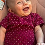 baby, infant, smiling, laughing, polka_dot, onesie, purple_clothing, cushion, quilted, soft_fabric, happy, child, cute, portrait, skin, arm, hand, head, face, indoor