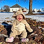 architecture, baby, building, clothing, coat, face, hat, head, hood, jacket, neighborhood, outdoors, pants, person, photography, plant, portrait, shelter, soil, tree