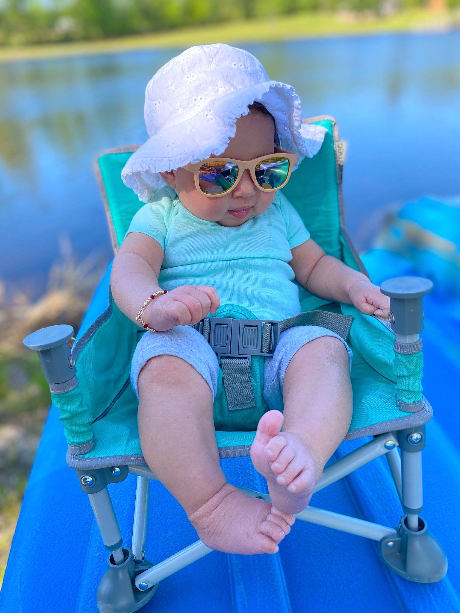 Ava is registered to the contest to win money with this photo: aqua, azure, baby_toddler_clothing, blue, cap, chair, electric_blue, eyewear, face, glasses, goggles, headwear, leisure, muscle, person, recreation, sleeve, summer, sunglasses, toddler