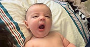 Tate joined the competition — help win amazing prizes! baby, infant, yawning, blanket, bed, pillow, striped_pillowcase, indoor, child, person, sleepy, cozy, furniture, room, blanket_clutch, head, skin, cute, toddler, relaxed