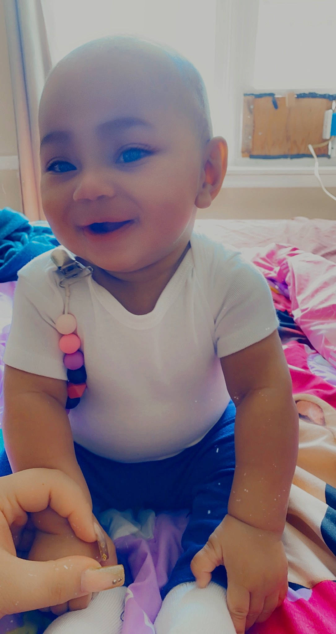 Kataleya is registered to the contest to win money with this photo: arm, baby_toddler_clothing, cheek, cool, face, finger, happy, head, human_body, iris, joy, mouth, neck, nose, person, pink, product, purple, skin, sleeve