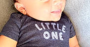 Zayden is registered to the contest to win money with this photo: arm, baby, blue_clothing, child, comfortable, cute, fabric, face, happy, head, human, indoors, infant, leg, onesie, portrait, sitting, skin, smiling, texture