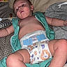 John is registered to the contest to win money with this photo: baby, infant, child, portrait, lying_down, bed, blanket, diaper, turquoise_clothing, bare_arms, bare_legs, pacifier, adult_hand, rings, indoors, home, flash_photography, sleeping_area, close_up, casual_photo