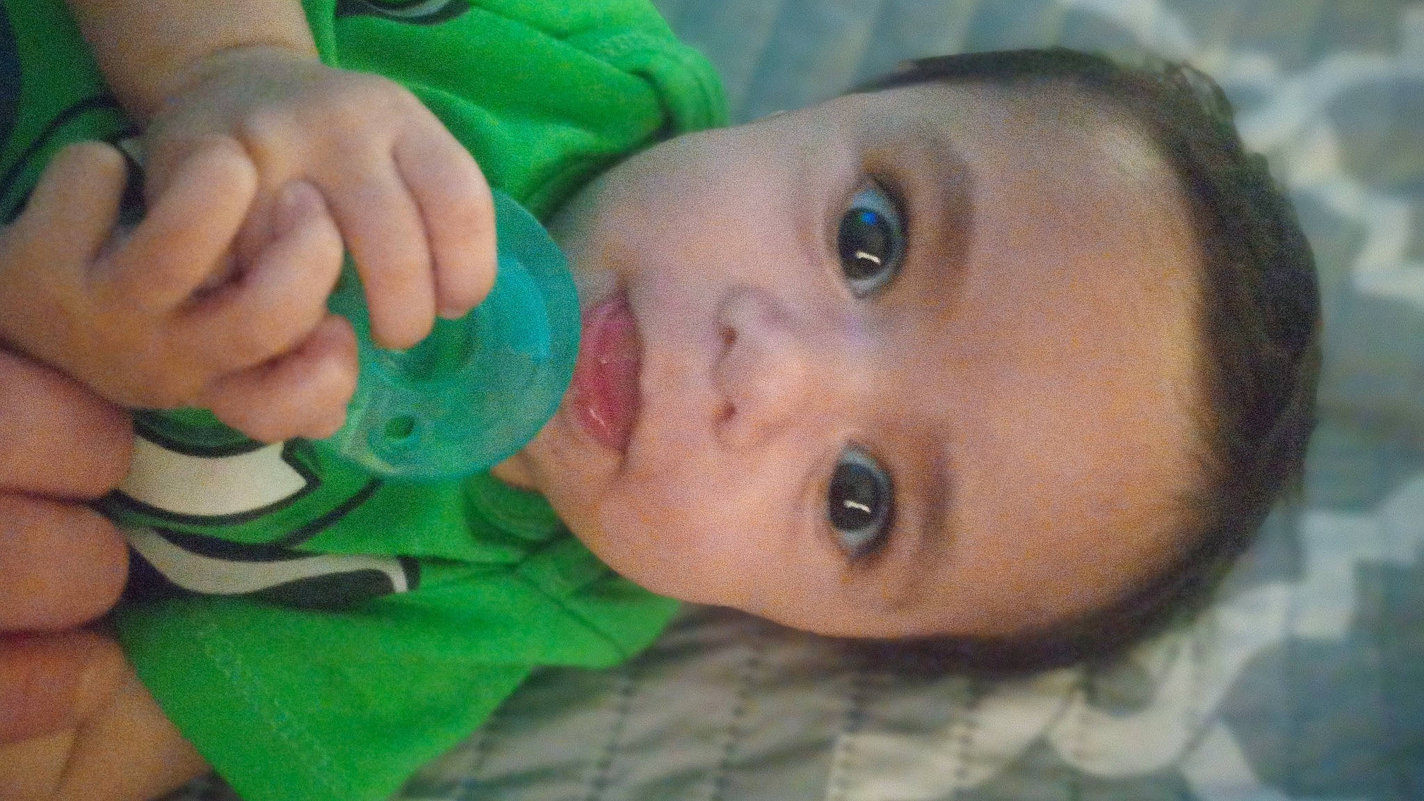 Eli is registered to the contest to win money with this photo: baby, baby_bottle, bottle, cheek, drinkware, eyebrow, eyelash, finger, gesture, hand, happy, human_body, iris, lip, mouth, nail, nose, person, plastic_bottle, skin