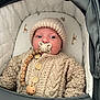 Grayson is registered to the contest to win money with this photo: baby, infant, knitwear, pacifier, stroller, beads, wooden_beads, hat, sweater, cute, child, face, portrait, cozy, neutral_colors, cushion, comfort, indoors, closeup, newborn