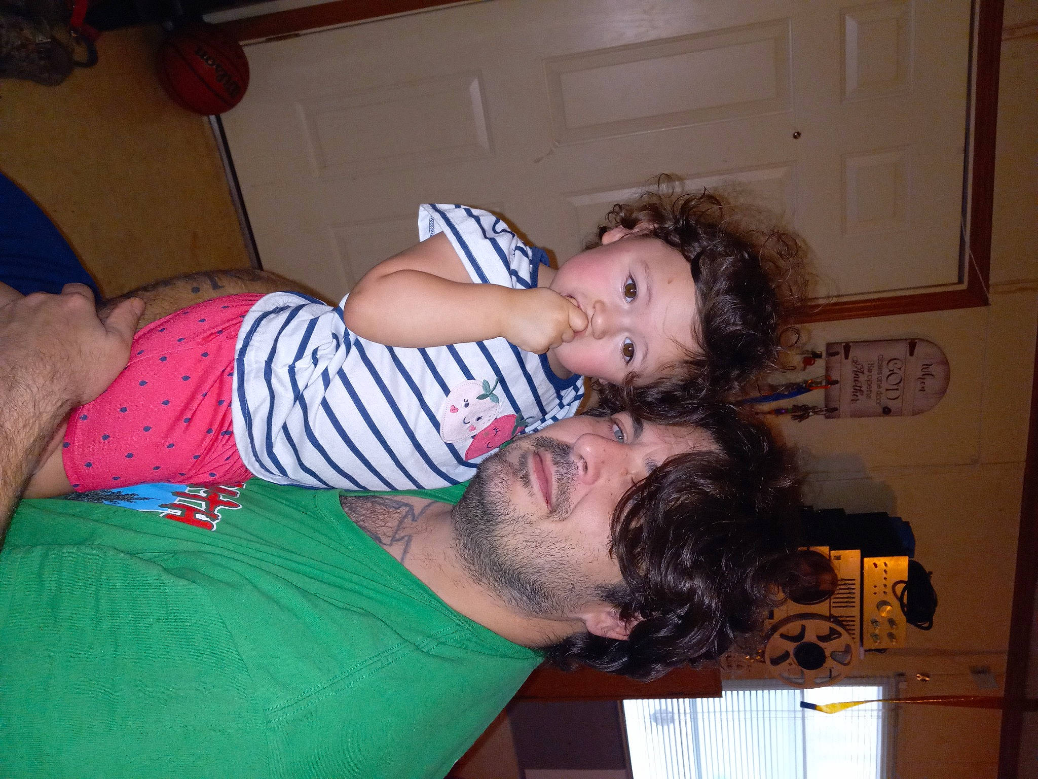 Olivia is registered to the contest to win money with this photo: abdomen, beard, chest, child, comfort, couch, elbow, fun, happy, human_leg, lap, mouth, pattern, person, room, sitting, t_shirt, thigh, trunk, vacation