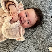 Lou participe au concours pour gagner de l'argent avec cette photo : baby, smiling, infant, sweater, cozy, couch, texture, hands, face, child, happy, cute, indoor, soft, warm, portrait, closeup, young, person, relaxing