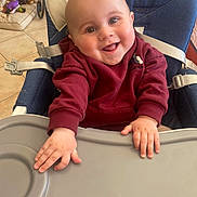 Clovis a rejoint le concours — aidez-le/la à gagner de superbes lots ! baby, child, clothing, cute, expression, face, feeding_chair, floor, hands, happy, high_chair, home, indoor, infant, person, seatbelt, smile, sweater, tile_floor, toy