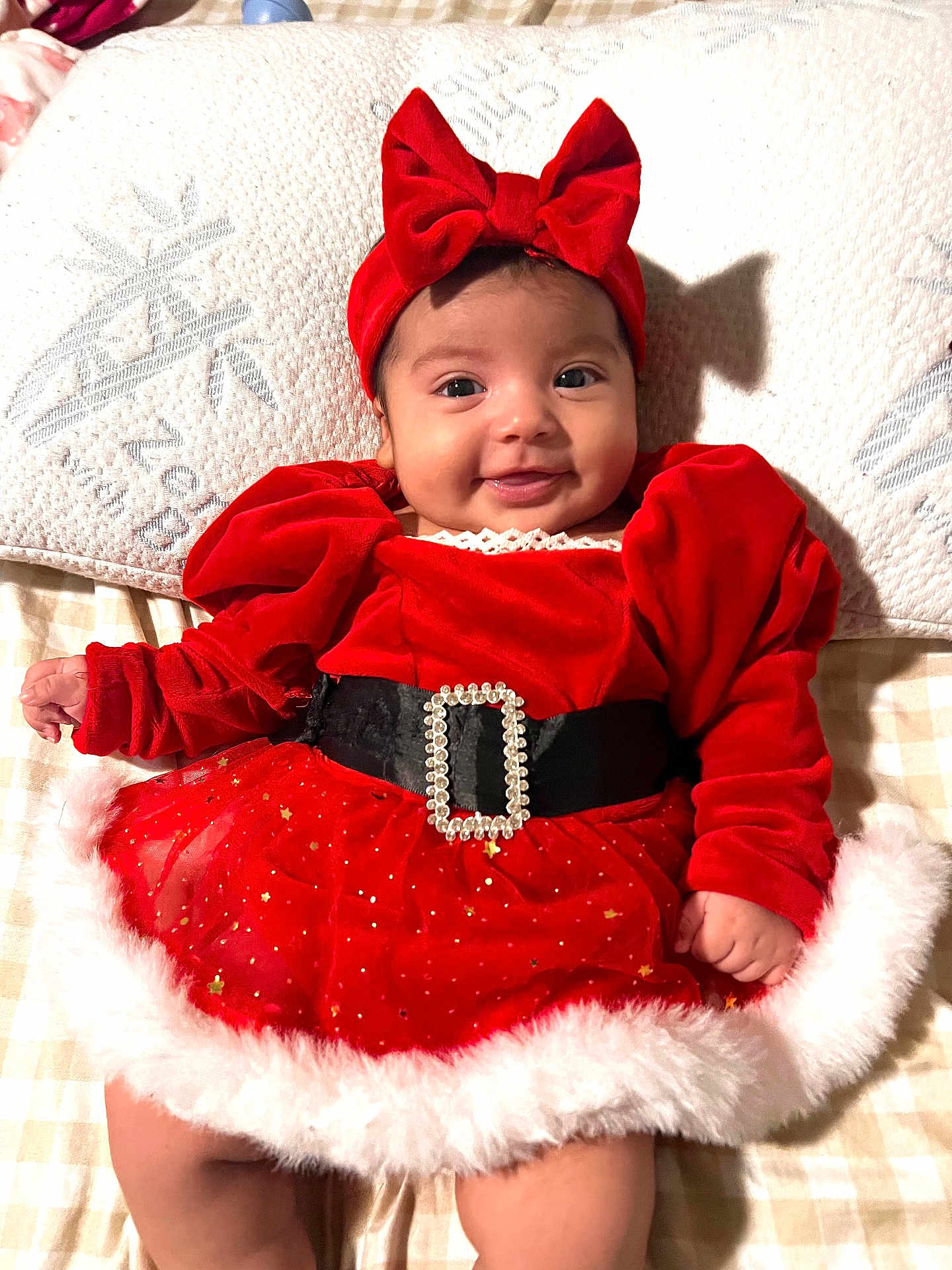 Mariel joined the competition — help win amazing prizes! baby, belt, blanket, bow, child, chubby_cheeks, cute, festive, fluffy_trim, happy, headband, holiday_outfit, indoors, infant, lying_down, portrait, red_dress, smiling, snowflake_pattern, velvet