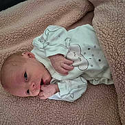 Kali joined the competition — help win amazing prizes! newborn, baby, blanket, onesie, infant, sleepwear, cute, cozy, soft_texture, face, hand, lying_down, bed, skin, expression, indoors, portrait, small, peaceful, resting