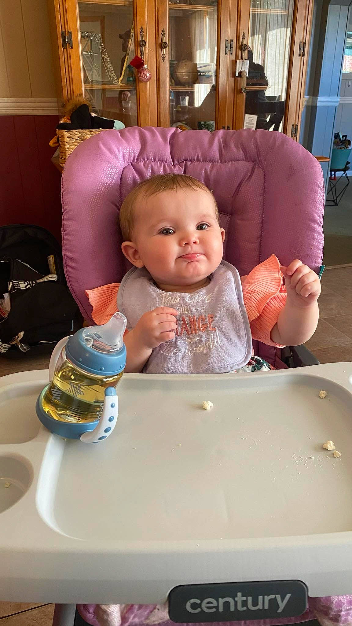 Athena is registered to the contest to win money with this photo: baby, baby_products, baby_toddler_clothing, bottle, child, comfort, drinking_water, drinkware, finger, fun, luggage_and_bags, person, picture_frame, plastic_bottle, product, room, sitting, skin, table, toddler