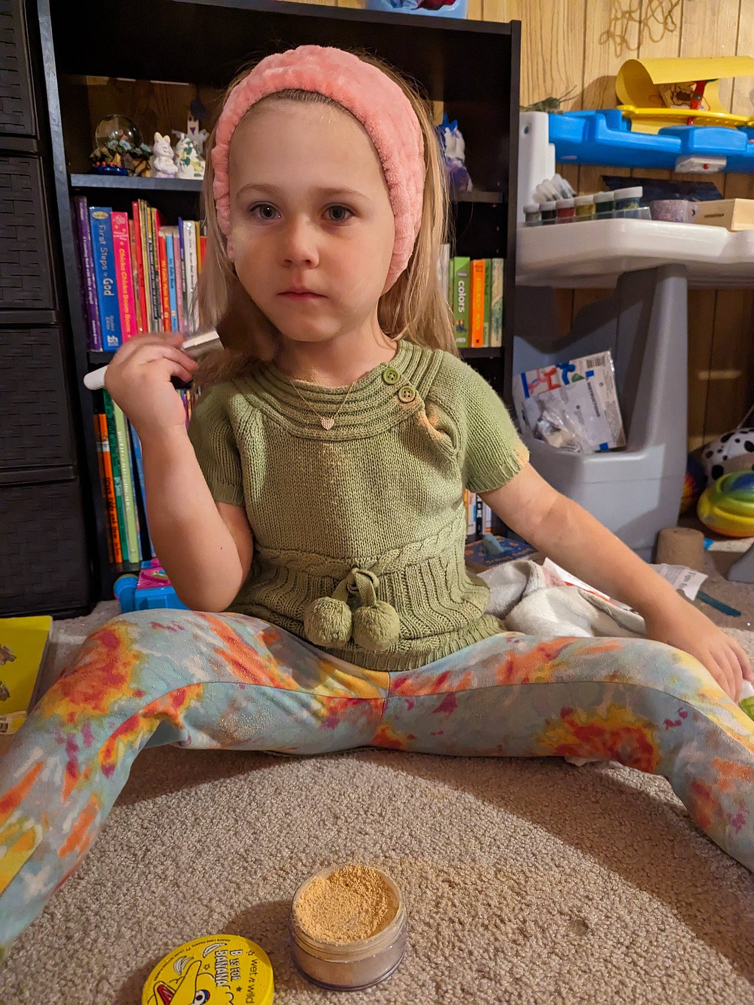 Madison is registered to the contest to win money with this photo: baby_toddler_clothing, bookcase, cap, chair, child, fashion_accessory, flooring, fun, headwear, human_leg, leisure, pattern, person, play, room, shelf, shelving, sitting, t_shirt, thigh