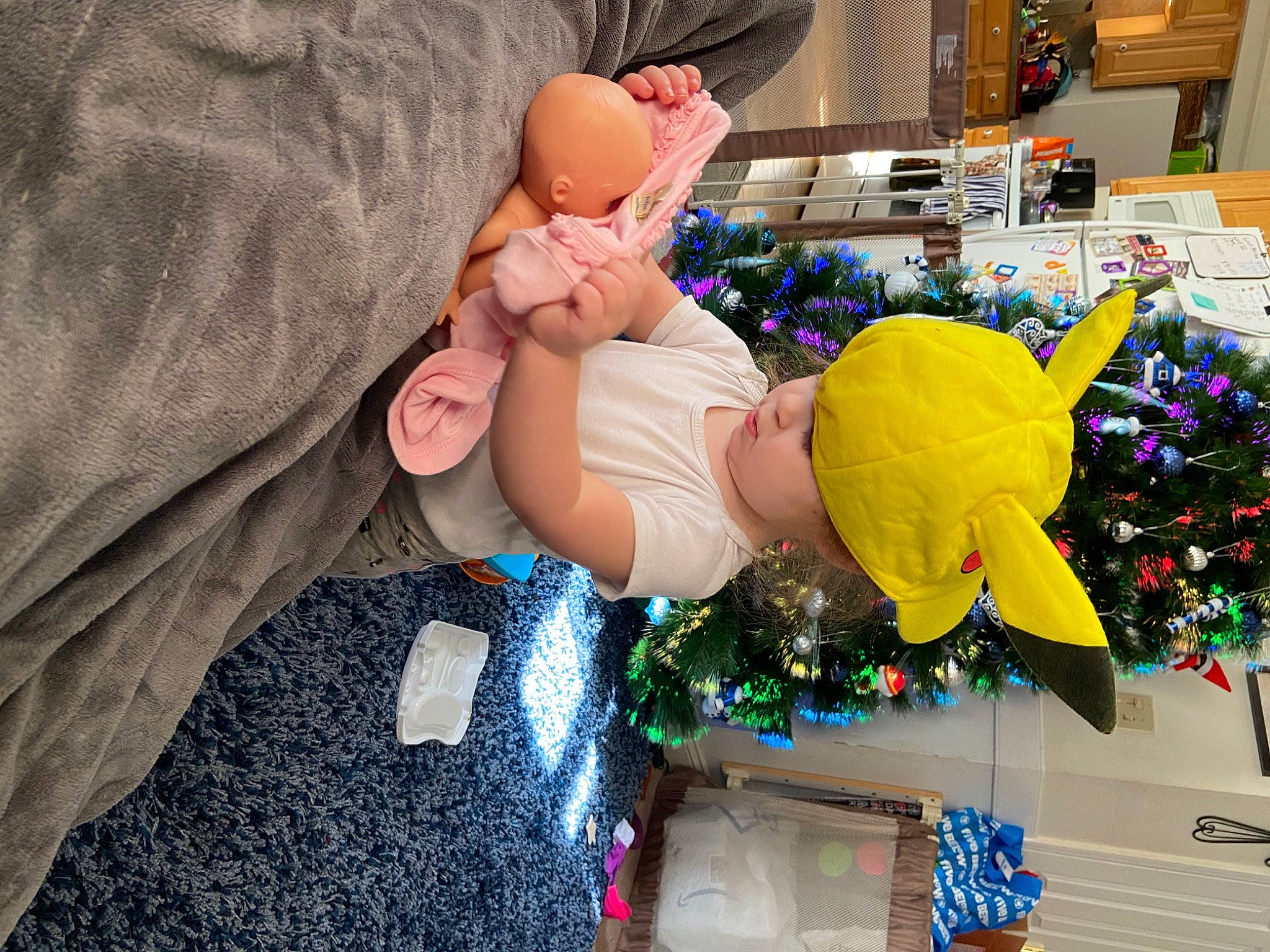 Crystal joined the competition — help win amazing prizes! baby, blue, child, christmas, christmas_decoration, christmas_eve, christmas_ornament, christmas_tree, event, fun, happy, headwear, holiday, holiday_ornament, lap, ornament, person, room, sitting, toddler