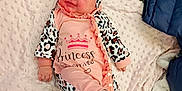 Roselynn is registered to the contest to win money with this photo: baby, infant, smiling, pink_outfit, leopard_print, headband, blanket, carpet, footwear, crawling, cute, happy, child, indoor, soft_texture, person, portrait, cozy, clothing, playful