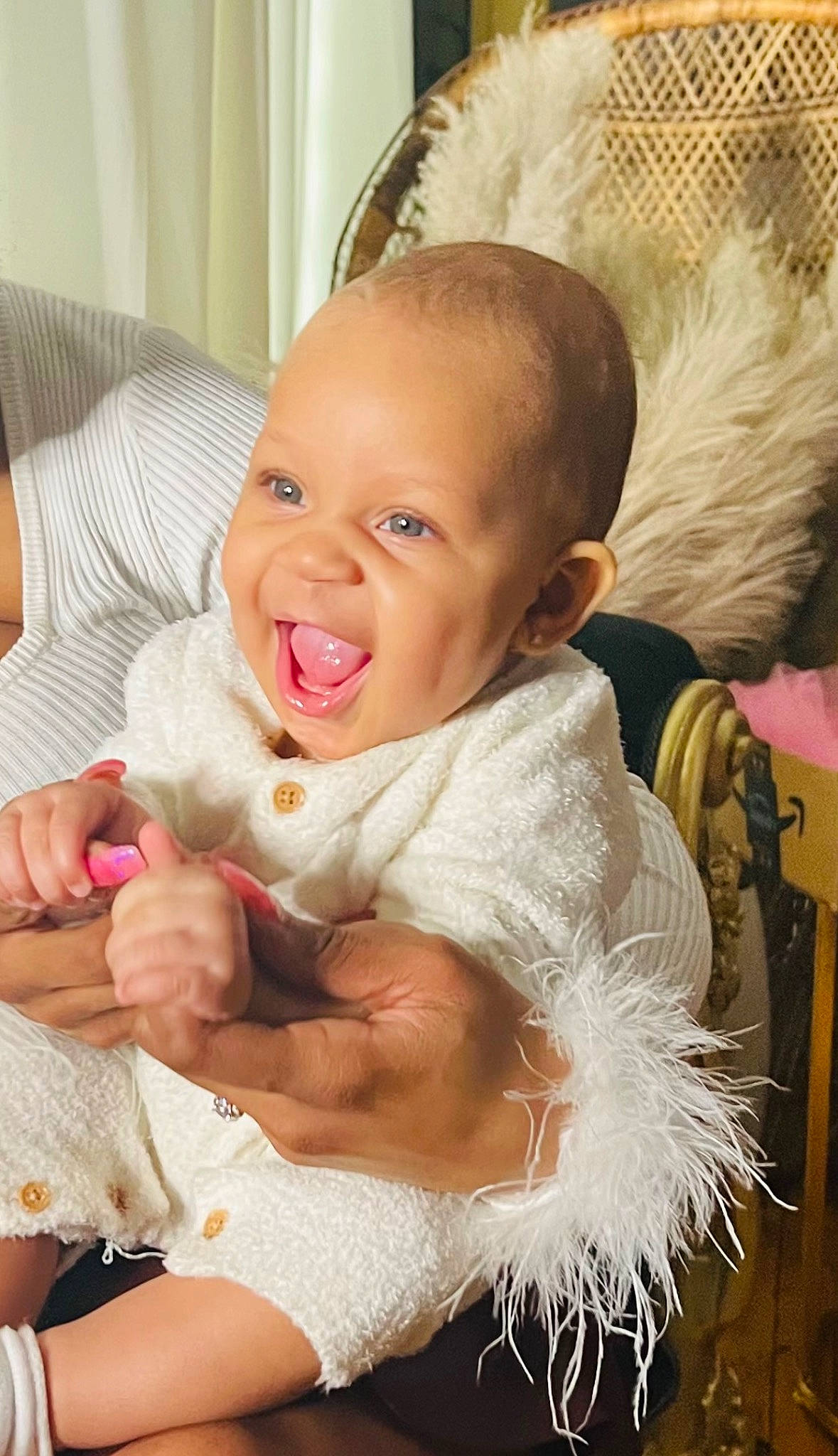 Amiri is registered to the contest to win money with this photo: baby, baby_toddler_clothing, chair, cheek, chin, comfort, ear, eye, gesture, hair, hand, happy, head, human_body, iris, lip, nose, person, skin, smile