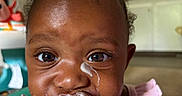 Lady joined the competition — help win amazing prizes! baby, child, food, eating, messy, face, closeup, pink_clothing, kitchen, indoor, person, hand, cream, dairy, cute, young_child, portrait, fingers, meal, dining