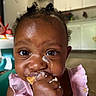 baby, child, food, eating, messy, face, closeup, pink_clothing, kitchen, indoor, person, hand, cream, dairy, cute, young_child, portrait, fingers, meal, dining