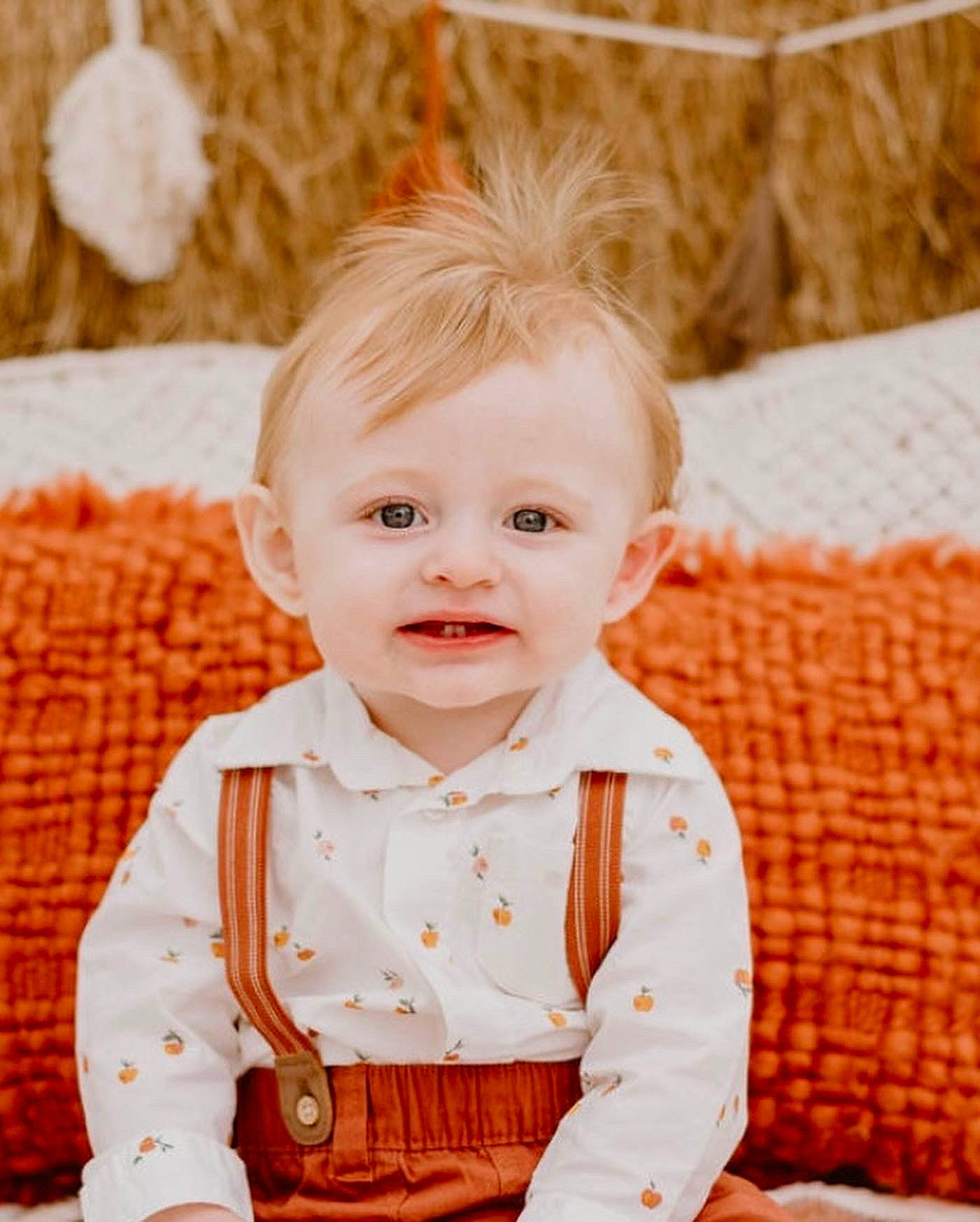 Elijah is registered to the contest to win money with this photo: baby, baby_toddler_clothing, cheek, child, collar, dress, dress_shirt, face, grass, happy, head, orange, pattern, peach, person, portrait_photography, sitting, sleeve, smile, toddler