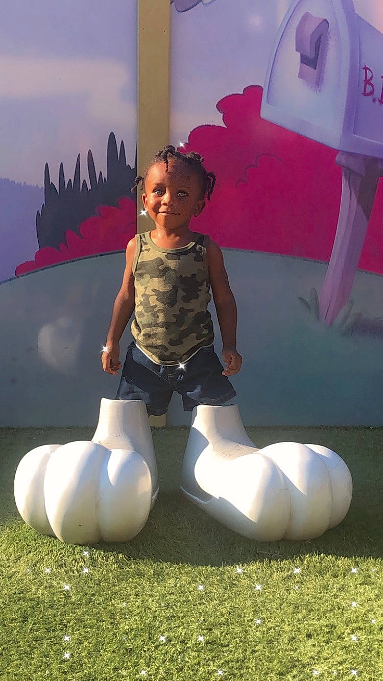 Dominick is registered to the contest to win money with this photo: art, balloon, child, flash_photography, fun, grass, happy, human_leg, inflatable, knee, leg, leisure, people_in_nature, person, photograph, pink, recreation, shorts, smile, thigh