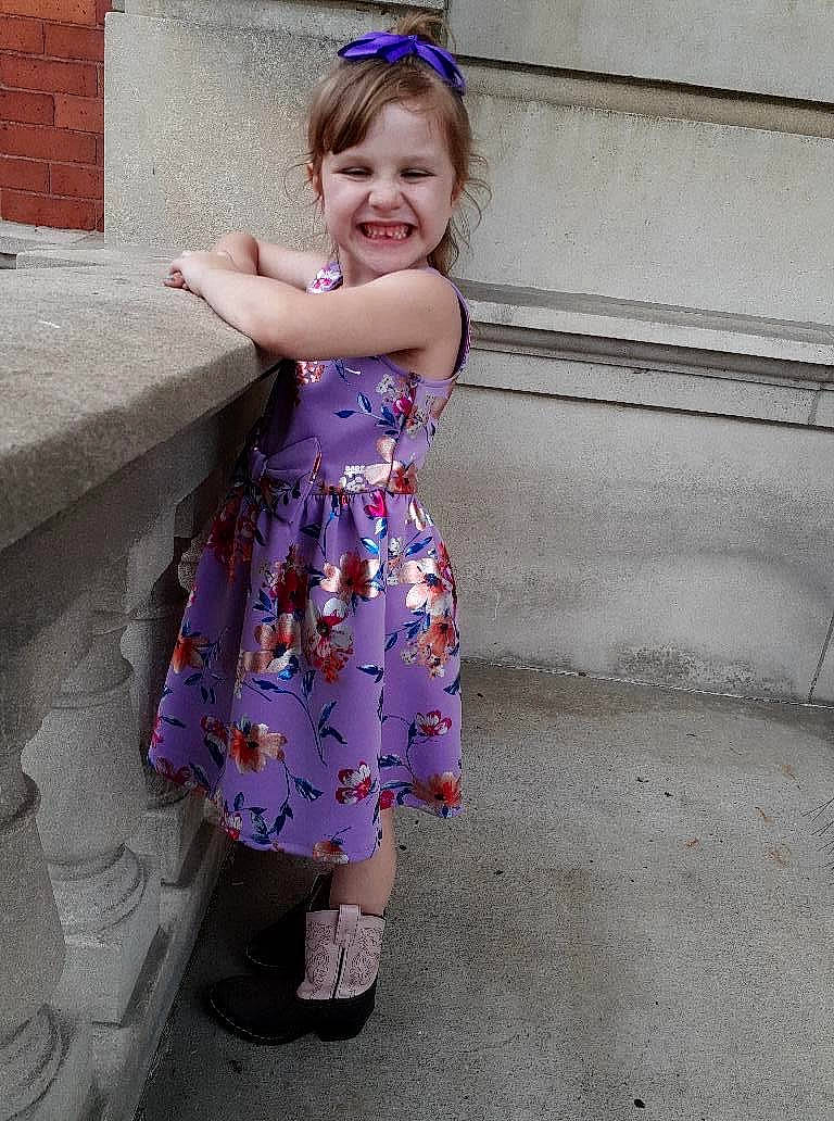 Rachel is registered to the contest to win money with this photo: child, child_model, clothing, day_dress, design, dress, fashion_accessory, footwear, hair_accessory, joy, lavender, pattern, person, pink, plant, purple, toddler