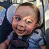 baby, smiling, face, child, car_seat, harness, clothing, infant, cute, happy, seatbelt, portrait, person, baby_boy, indoor, closeup, head, skin, eyelashes, cheeks