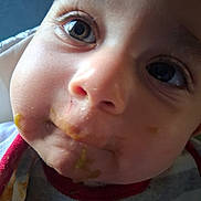 Knox is registered to the contest to win money with this photo: baby, face, closeup, messy, food, mouth, eyes, skin, child, infant, curious, expression, clothing, bib, cheeks, portrait, cute, young, person, indoor