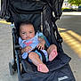 Kyomi joined the competition — help win amazing prizes! baby, stroller, infant, outdoor, daylight, baby_bottle, clothing, feet, black_stroller, concrete, child, person, cute, pink, flamingo, diaper, sunlight, trees, seatbelt, relaxing