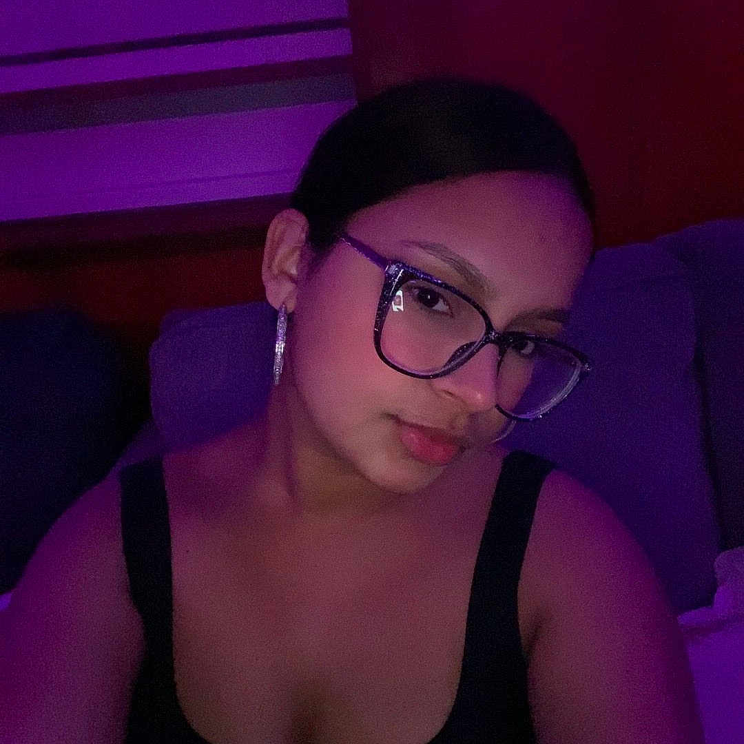 Darmelis joined the competition — help win amazing prizes! black_top, casual, dim_lighting, earrings, eyewear, face, fashion, female, glasses, head, indoor, mood_lighting, person, portrait, purple_light, relaxed, shoulders, skin, sofa, young_adult