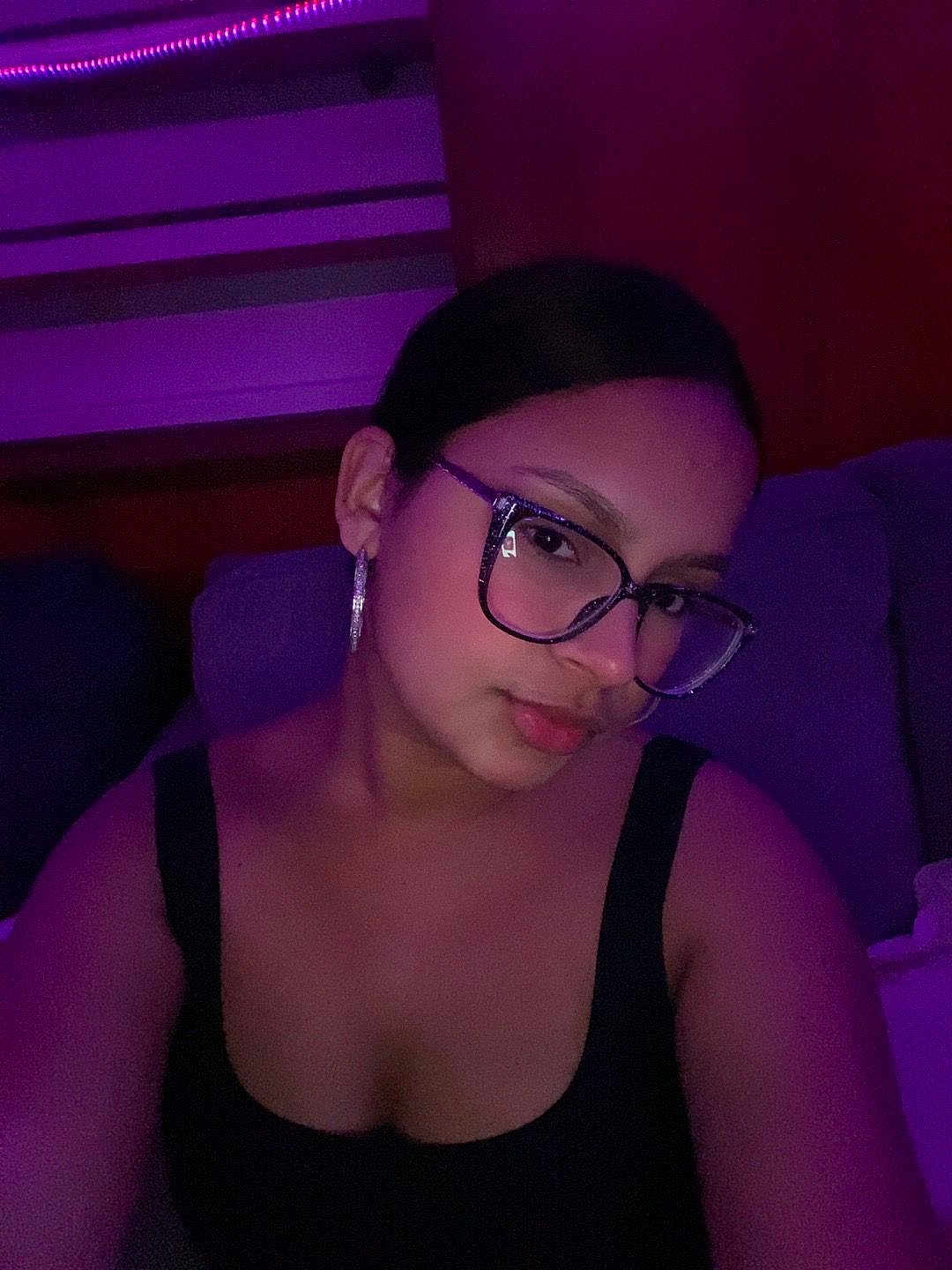 Darmelis joined the competition — help win amazing prizes! black_top, casual, dim_lighting, earrings, eyewear, face, fashion, female, glasses, head, indoor, mood_lighting, person, portrait, purple_light, relaxed, shoulders, skin, sofa, young_adult