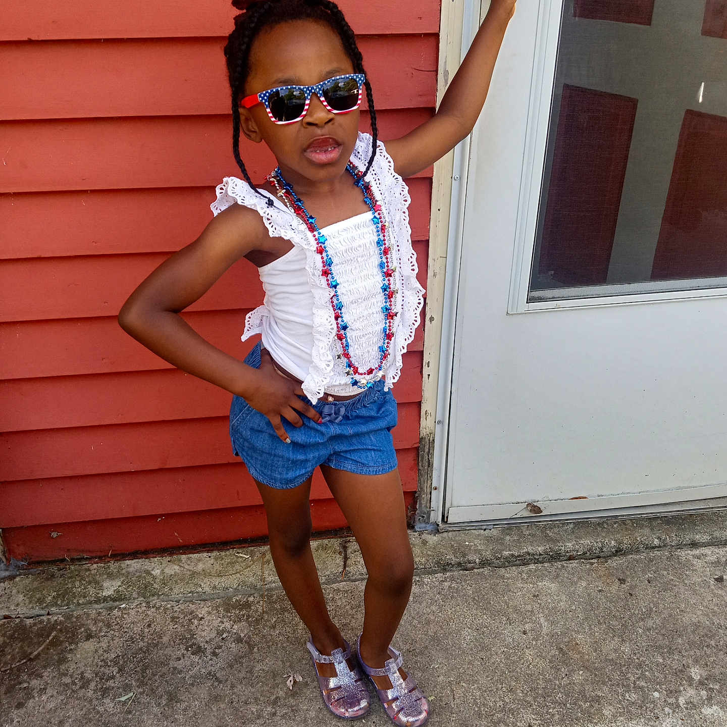 Zazie is registered to the contest to win money with this photo: accessories, bodypart, child, clothing, door, face, female, footwear, girl, head, jewelry, necklace, pants, person, photography, portrait, sandal, shoe, shorts, sunglasses