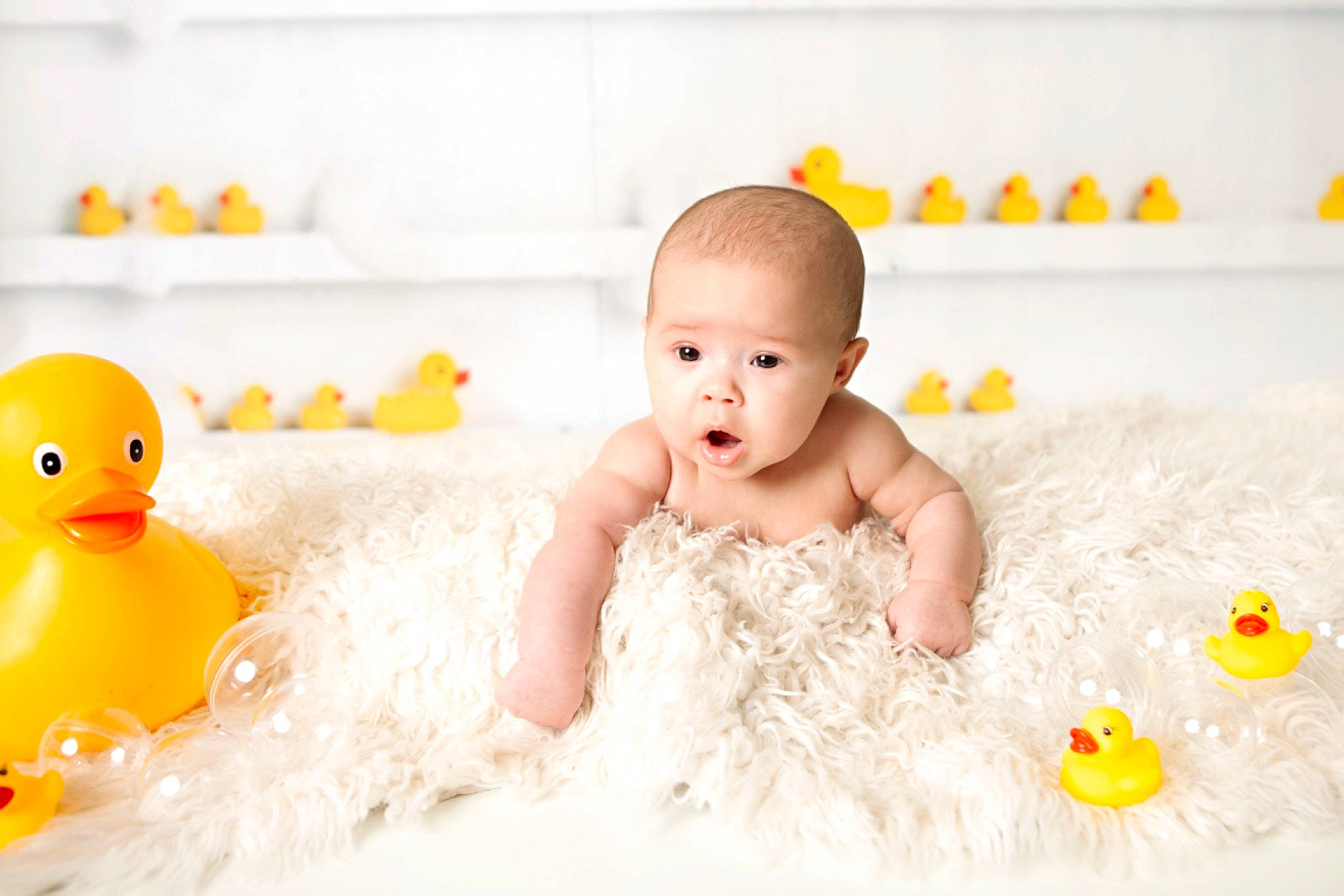 Madeleine joined the competition — help win amazing prizes! baby, baby_bathing, bath_toy, bathing, bathtub, child, duck, head, person, photograph, photography, portrait_photography, product, room, rubber_ducky, skin, smile, stock_photography, surprise, toddler
