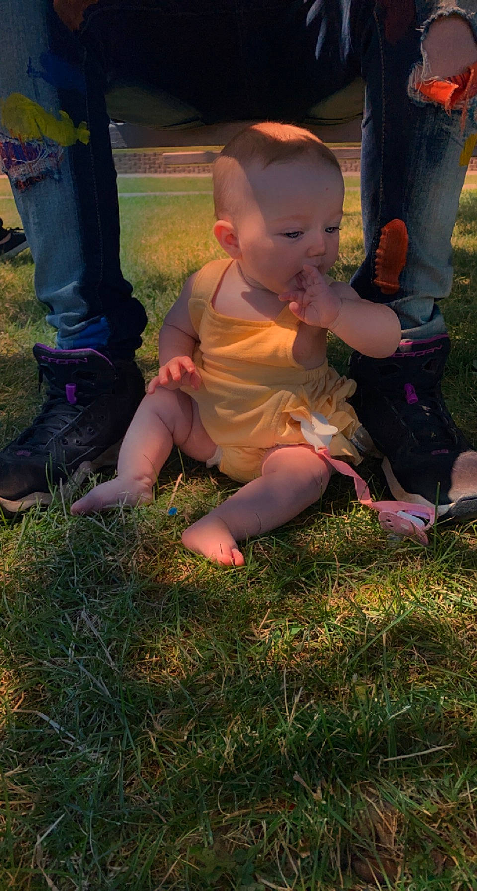 Novah is registered to the contest to win money with this photo: baby, child, finger, foot, fun, grass, grassland, happy, hat, human_leg, lawn, leg, people_in_nature, person, sandal, shoe, sitting, sneakers, thigh, thumb