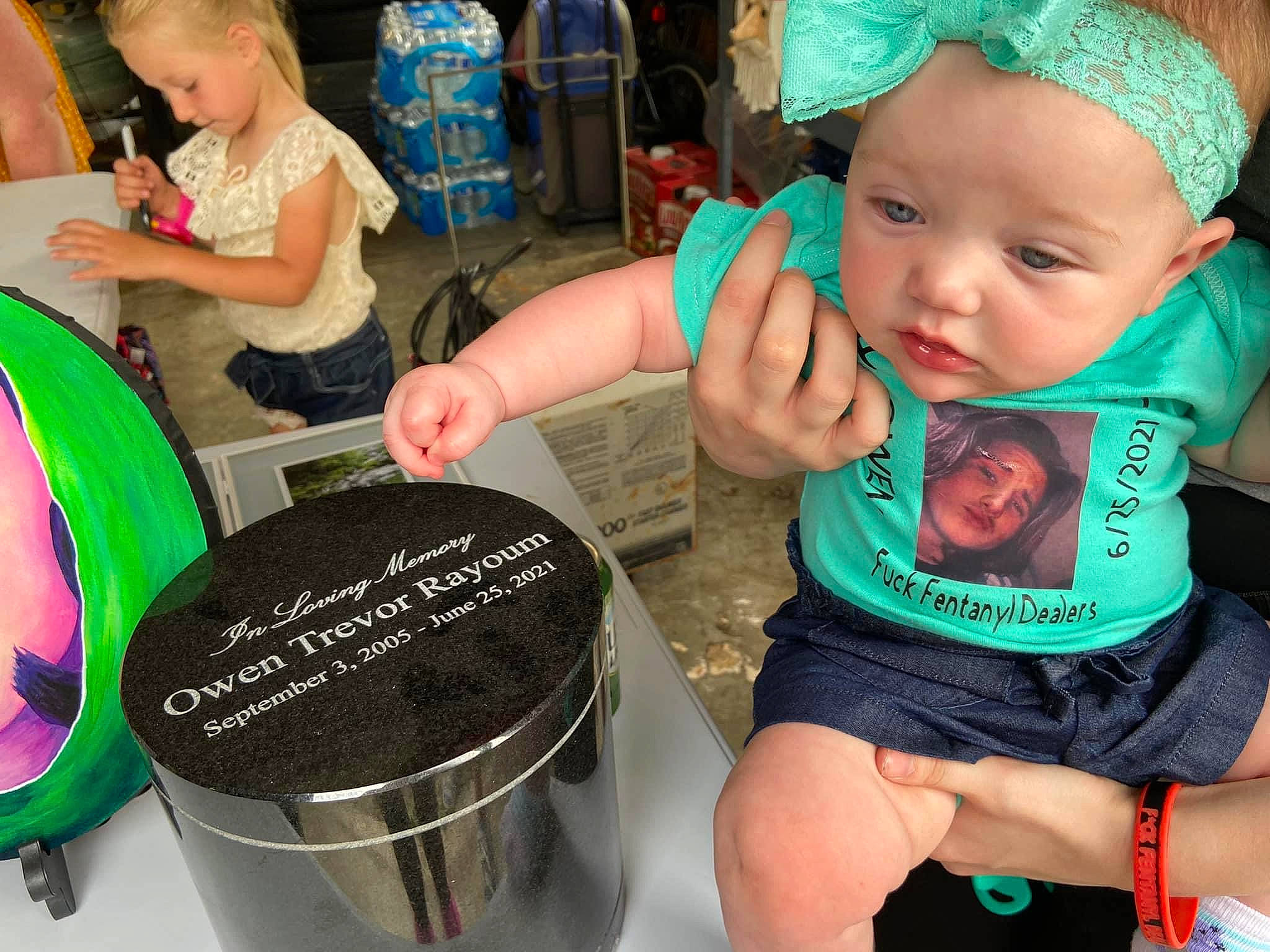 Novah is registered to the contest to win money with this photo: automotive_wheel_system, baby, baby_toddler_clothing, chair, child, event, fun, green, hairstyle, happy, headwear, human, organ, person, pink, sharing, shorts, sitting, snapshot, t_shirt