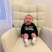 Cassius joined the competition — help win amazing prizes! armchair, baby, child, christmas, clothing, cozy, cute, decor, face, furniture, happy, holiday, indoor, infant, onesie, person, pose, seated, smiling, socks