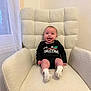 armchair, baby, child, christmas, clothing, cozy, cute, decor, face, furniture, happy, holiday, indoor, infant, onesie, person, pose, seated, smiling, socks