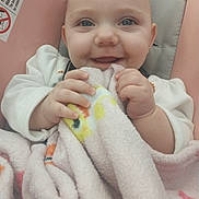 Emberlynn joined the competition — help win amazing prizes! baby, blanket, blue_eyes, cushion, cute, face, hands, infant, joyful, light_skin, looking_at_camera, person, pink, portrait, seat, smiling, soft_texture, white_clothing, wrapped, young_child