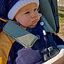 Tommy participe au concours pour gagner de l'argent avec cette photo : baby, child, stroller, winter_clothing, hat, sunglasses, blanket, outdoor, pout, face, bundle, warm, jacket, seatbelt, infant, cute, portrait, daylight, babywear, expression