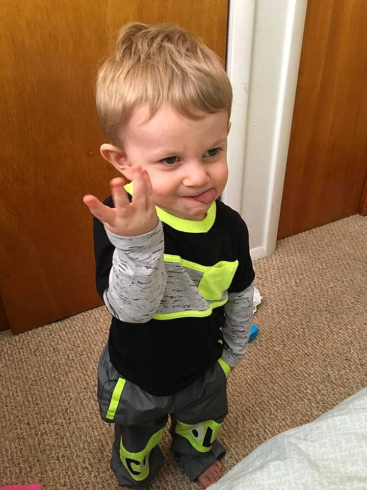 Timothy is registered to the contest to win money with this photo: arm, baby, blond, child, finger, joint, leg, outerwear, person, play, skin, sleeve, smile, standing, t_shirt, thumb, toddler