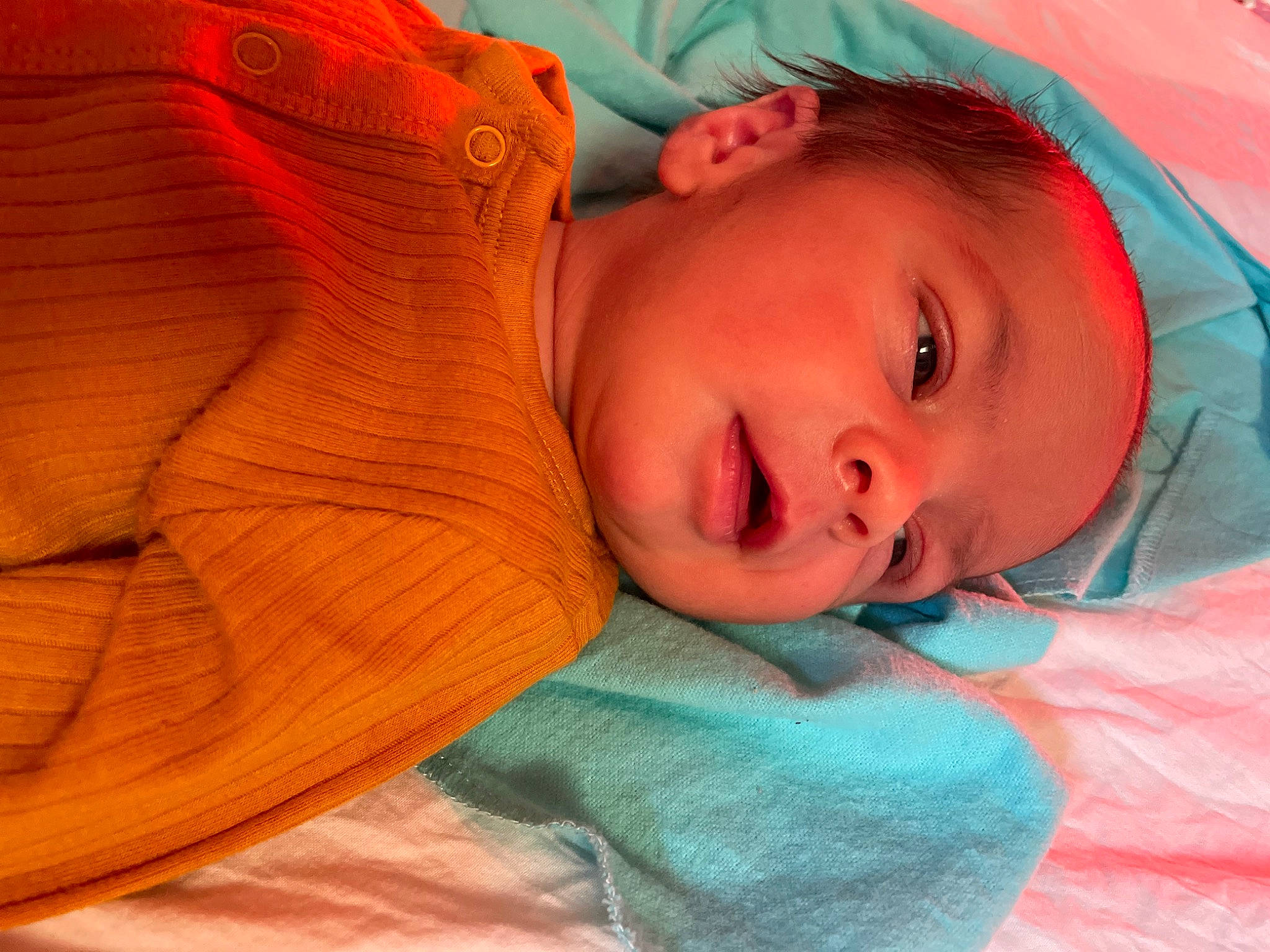 Drew is registered to the contest to win money with this photo: baby, baby_toddler_clothing, cheek, child, chin, comfort, electric_blue, fun, happy, headwear, iris, linens, lip, mouth, neck, nose, orange, pattern, person, skin