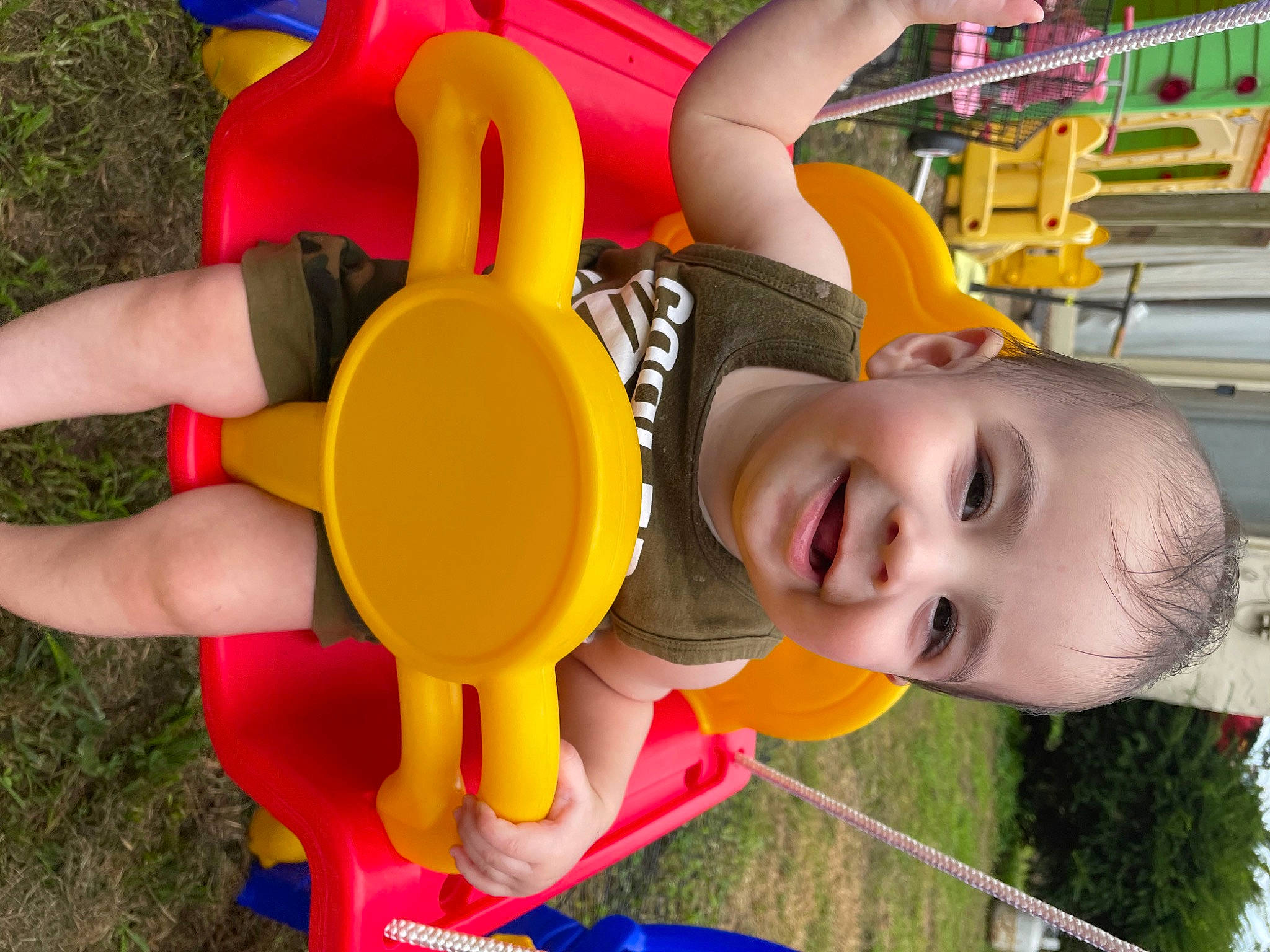 Drew joined the competition — help win amazing prizes! automotive_wheel_system, baby, child, city, facial_expression, fun, grass, green, happy, joy, leisure, outdoor_play_equipment, person, photograph, play, recreation, shorts, smile, snapshot, toddler