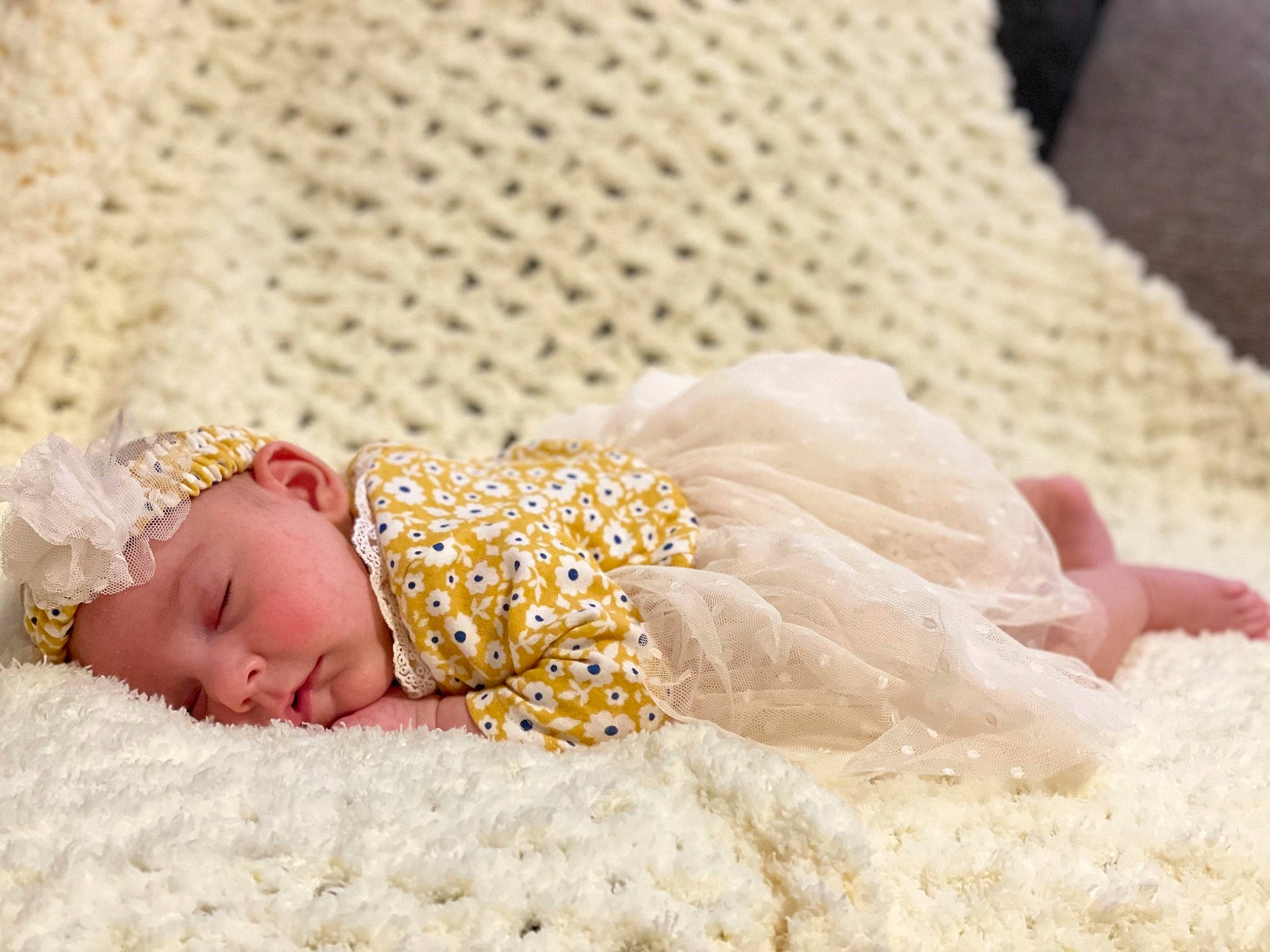 Kynlee is registered to the contest to win money with this photo: baby, baby_sleeping, baby_toddler_clothing, bedding, child, comfort, embellishment, fashion_accessory, flooring, fur, hair_accessory, happy, headgear, headwear, linens, pattern, person, portrait_photography, sitting, sleep