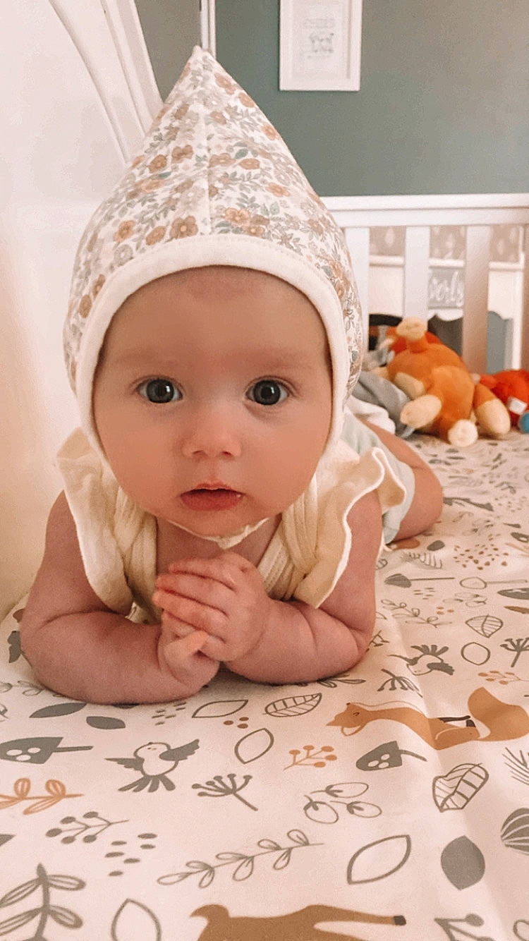 Everly joined the competition — help win amazing prizes! baby, baby_toddler_clothing, cap, cheek, clothing, comfort, eye, face, finger, flooring, fun, happy, head, headgear, headwear, lip, mammal, person, pink, skin
