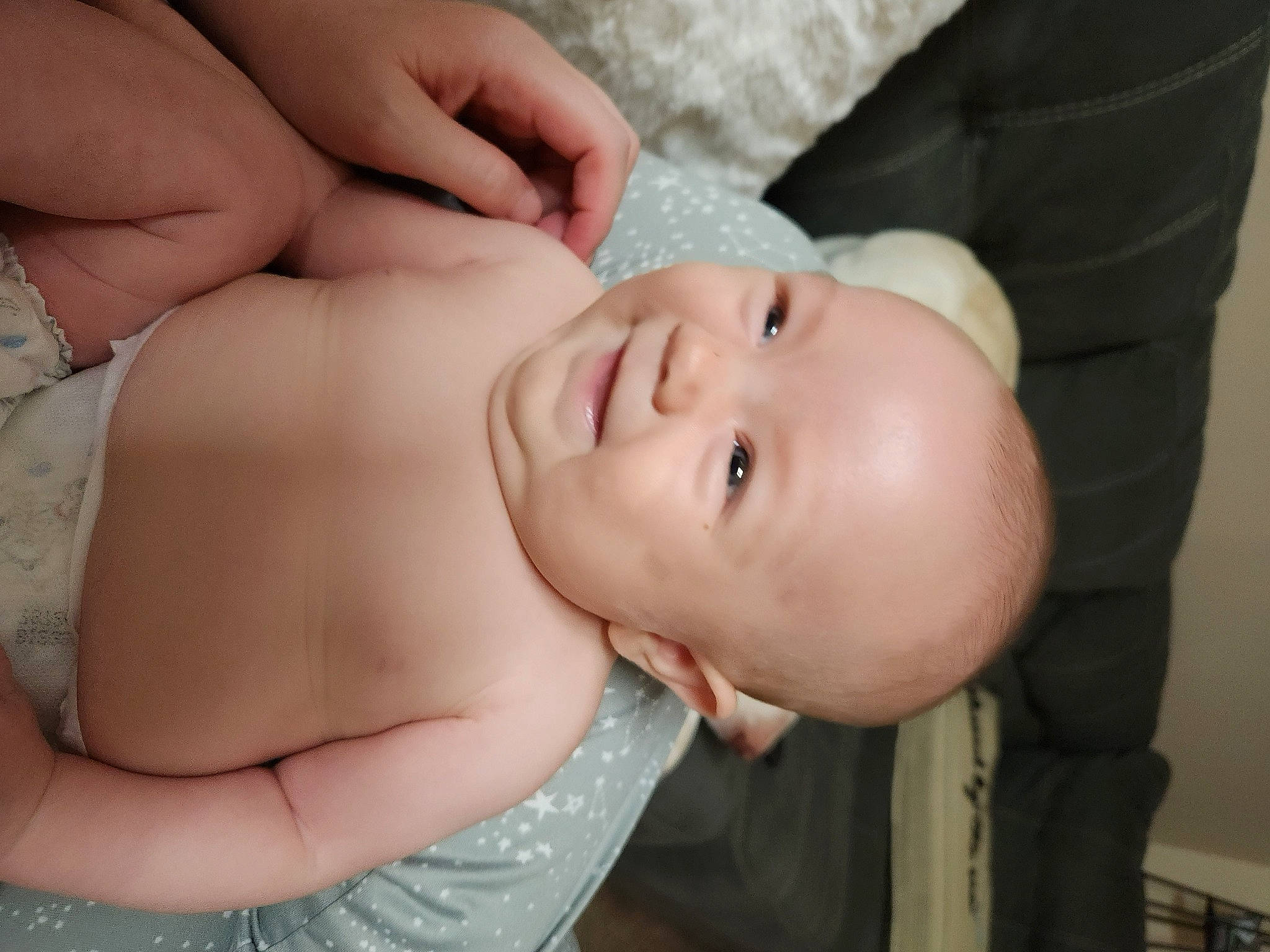 Macie is registered to the contest to win money with this photo: arm, baby, baby_toddler_clothing, cheek, chest, comfort, eye, eyelash, finger, gesture, happy, human_body, iris, lip, mouth, neck, nose, person, skin, stomach